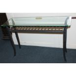 A contemporary console or hall table, the bevelled glass rectangular shaped top with reticulated