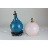 A turquoise crackle glaze pottery table lamp on hardwood base, together with a pale pink glass table