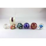 Five various coloured glass paperweights including two by Mdina, and a boxed Thun pottery