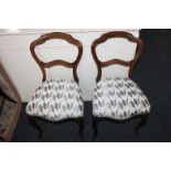 A pair of Victorian chairs with open framed backs, recently upholstered seats, on cabriole legs