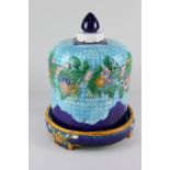 A majolica cheese dish and cover with floral design on blue ground, 30cm high