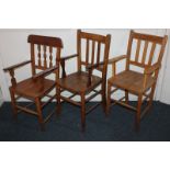 Three various child's wooden chairs of similar design with slatted backs and solid seats