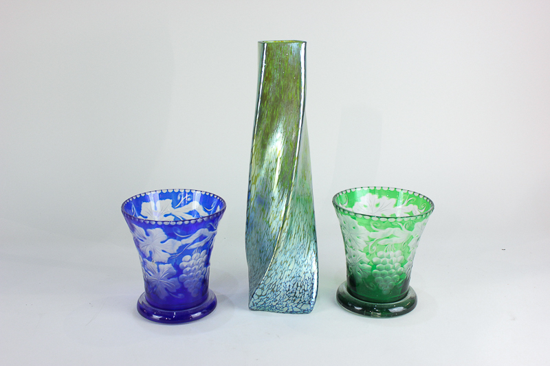 A studio glass vase of tapering twisted form in opalescent green, together with a near pair of