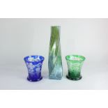 A studio glass vase of tapering twisted form in opalescent green, together with a near pair of