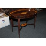 An oval inlaid galleried tray with central urn cartouche on stand