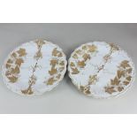 A pair of Meissen porcelain plates the relief moulded vine design with gilt embellishments,