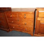 A pine chest of two short over two long drawers, with brass lock plates and turned knob handles,