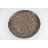 An Indian copper wall plate embossed with hunting scenes amongst floral decoration, 37cm diameter (