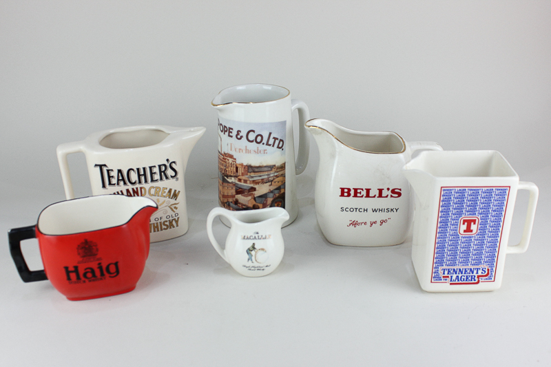 A Haig porcelain whisky jug with black lettering on red ground, 9cm high, together with five other