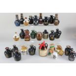 A collection of miniature crocks and pottery decanters containing whisky, mead and other spirits, to
