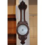 A carved oak banjo aneroid barometer with detachable thermometer 90cm