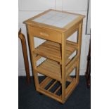 A modern kitchen island unit with tiled top and drawers, slatted shelves beneath, on castors, 38cm