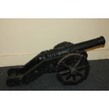 A black painted cast iron model of a cannon, 75cm