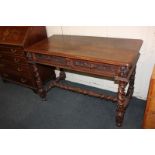 A carved oak side table, with rectangular shaped top and two drawers, with foliate decoration, on