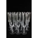 A set of twelve Igor Carl Fabergé crystal champagne flutes, the frosted stems modelled as two