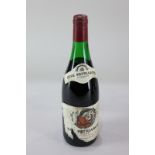 A bottle of Patriarche Père et Fils red wine, partial paper label