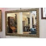 A modern rectangular gilt framed wall mirror with pierced scrolling foliate frame, mirror plate 59cm