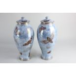 A pair of Carlton Armand lustre ware baluster vases and covers, decorated with butterflies (one with