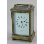 A brass cased carriage clock, the white enamel dial with Roman numerals, marked F.E. Rutherford