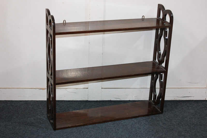 A mahogany three-tier hanging set of wall shelves, with decorative pierced sides, 76cm