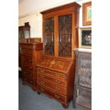 An Edwardian inlaid mahogany bureau bookcase with twin panel glazed top enclosing shelves, above