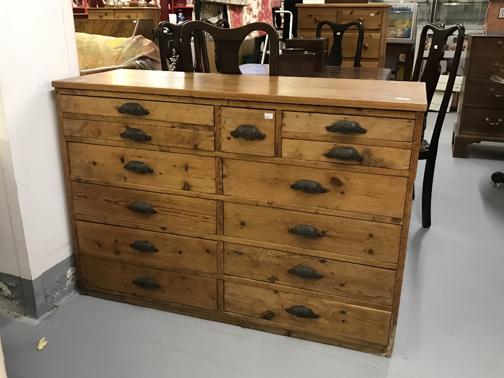 Early 20th cent. Pitched pine printers desk with thirteen drawers of various depth & fittings.