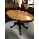 19th cent. Mahogany oval loo tilt top table, single turned column on 4 splayed supports.