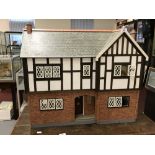 20th cent. Dolls House: Tudor style with some furniture.