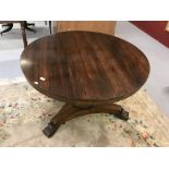 20th cent. Rosewood, circular tilt top dining table on a single pedestal, with carved tripod