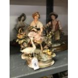 20th cent. Ceramics: Capo di monte, country boy and girl, a pair plus goose girl.