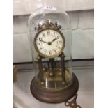 Clocks: 20th cent. Anniversary clock mounted on a plinth and under a glass dome.