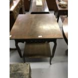 20th cent. Oak two tier occasional table with pierced frieze and shaped supports, retail label "