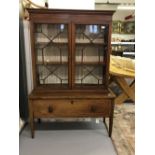 Edwardian mahogany bookcase on stand with inlaid stringing and dental frieze.