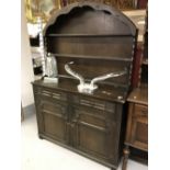 20th cent. Oak dresser, the base having two doors opening to reveal single shelf over two drawers.