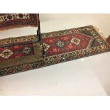 Rugs: 20th cent. Kazak style runner red ground with twelve gûls in alternative blue and beige