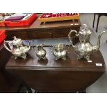 Platedware: Britannia metal tea and coffee service. Embossed floral decoration with a hawk finial,