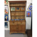 19th cent. Pine dresser, two drawers over a twin door cupboard with a three shelf rack above. The