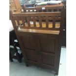 20th cent. Arts & crafts oak two door cupboard with twin gallery above. 23½ins. x 42ins. x 13½ins.