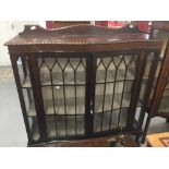 20th cent. Mahogany serpentine fronted display cabinet, ball & claw feet. 48ins. x 51ins. x 13½ins.