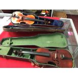 Musical Instruments: 20th cent. Two three quarter size violins in cases, one with bow.