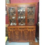 20th cent. Yew wood veneer bookcase cupboard, three door, and three drawer base with three glazed