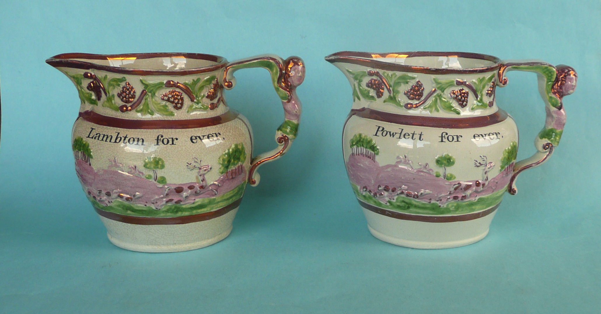 1820 General Election: a rare pair of pink lustre jugs set with elaborate figural handles the bodies