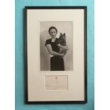 Duchess of Windsor: a photograph depicted wearing a black dress holding a terrier dog mounted