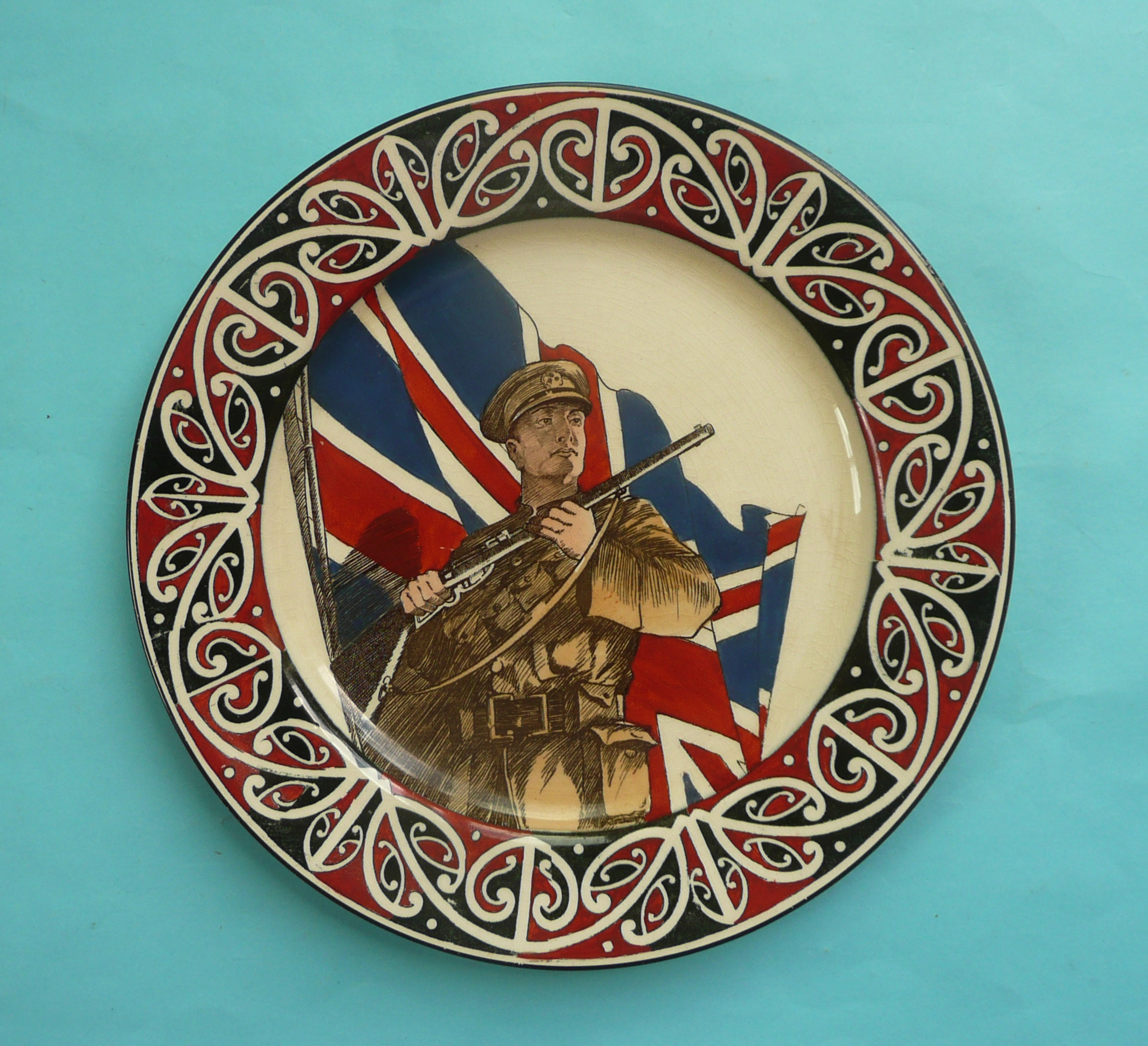 World War I: a Royal Doulton plate stylishly decorated with a soldier against the Union flag, the