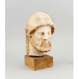 Marmorbüste im archaisch griechischen Stil, lächelnder Männerkopf mit gewelltem Bart undlangem Haar,