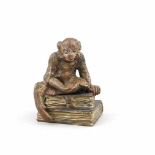 Wiener Bronze, 1. H. 20. Jh.,auf zwei Büchern sitzender Affe mit Löffel, polychrom bemalteBronze,