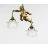 Deckenlampe, 20. Jh., Messing, schwebender Putto, 2 blütenförmige Glasschirme (besch.)haltend,