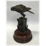 A PATINATED METAL SCULPTURE OF A HAWK ON