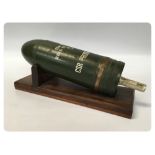 TANK BUSTER SHELL CASE ON WOODEN PLINTH