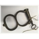 A PAIR OF LATE 19TH CENTURY IRON HANDCUF